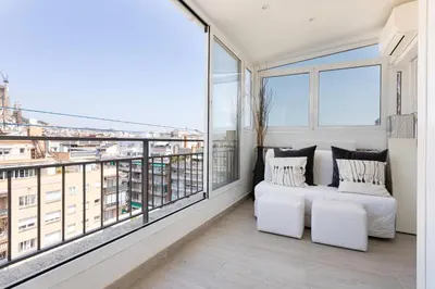 a bedroom with a bed and a large window at Fantastic view penthouse apartment in Barcelona