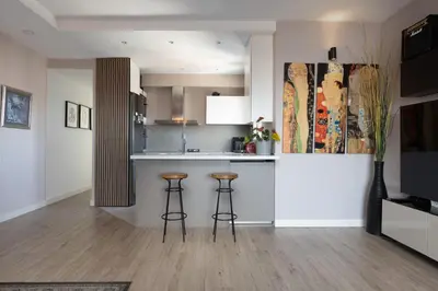 a kitchen with a counter and stools in a room at Fantastic view penthouse apartment in Barcelona