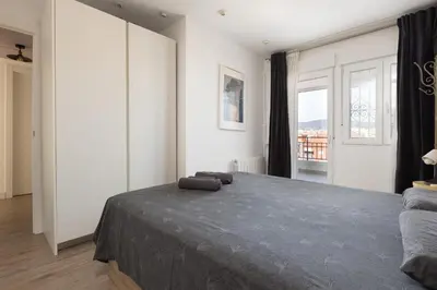 a bedroom with a large bed and a window at Fantastic view penthouse apartment in Barcelona