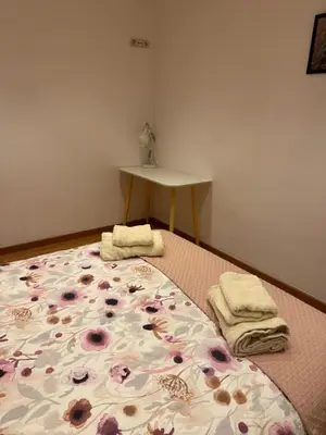 a bed with two towels and a table in a room at 2 bedroom apartment Barcelona Center in Barcelona