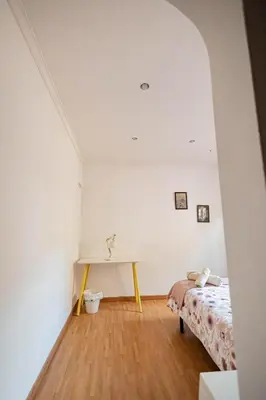 a bedroom with a table and a bed in a room at 2 bedroom apartment Barcelona Center in Barcelona