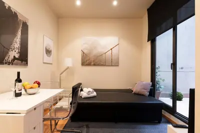a balcony with chairs and a table on a building at 2762 - AB Park Guell Apartment B-II in Barcelona