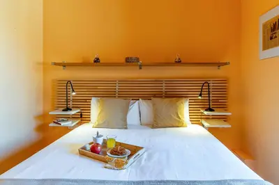 a bedroom with a bed with a tray of fruit on it at 4179 - AB Verdi Villa de Gracia Apartment in Barcelona