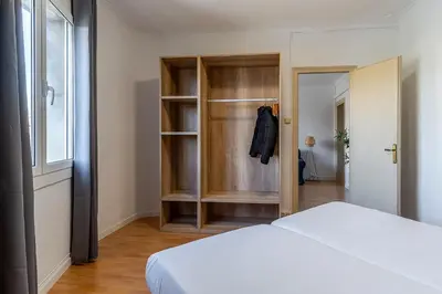 a bedroom with a white bed and a closet at 4254 - AB Sagrada Familia Views III-II in Barcelona