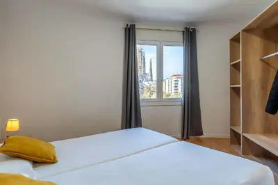 a bedroom with a bed and a window with a view at 4254 - AB Sagrada Familia Views III-II in Barcelona