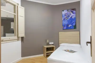 a bedroom with a bed and a painting on the wall at 4254 - AB Sagrada Familia Views III-II in Barcelona