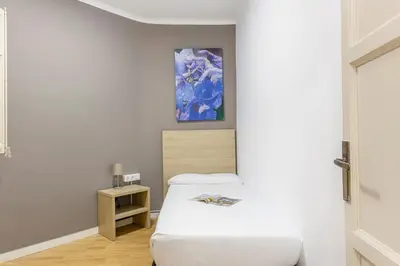 a bedroom with a bed and a painting on the wall at 4254 - AB Sagrada Familia Views III-II in Barcelona