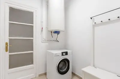 a white laundry room with a washing machine and a window at 4254 - AB Sagrada Familia Views III-II in Barcelona