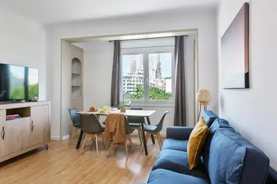 a living room with a blue couch and a table at 4254 - AB Sagrada Familia Views III-II in Barcelona