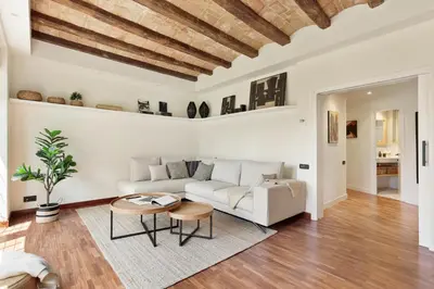 a living room with a white couch and a table at Enjoy Apartments La Riera Principal in Barcelona