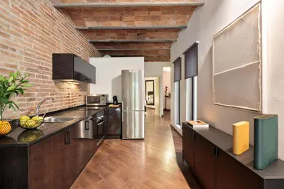 a kitchen with a brick wall and a counter top at Enjoy Apartments Urban Retreat Valencia 4 in Barcelona