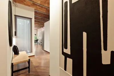 a hallway with a black and white wall at Enjoy Apartments Urban Retreat Valencia 4 in Barcelona
