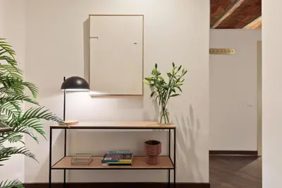 a room with a table with a plant and a mirror at Enjoy Apartments Urban Retreat Valencia 1 in Barcelona