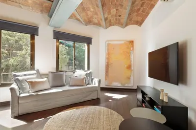 a living room with a couch and a flat screen tv at Enjoy Apartments Urban Retreat Valencia 1 in Barcelona