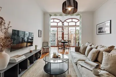 a living room with a couch and a tv at Zamora - 3 bedrooms in Eixample Esquerra in Barcelona
