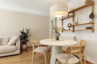 a living room with a table and chairs and a couch at Cerca de la Playa y El Born, con Piscina in Barcelona