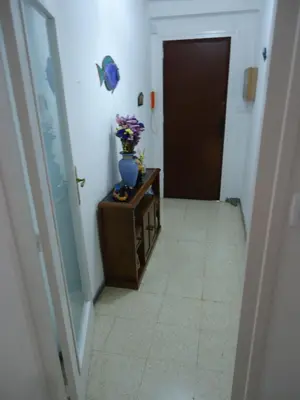 a hallway with a vase of flowers on a table at brisa mar in San Pol de Mar