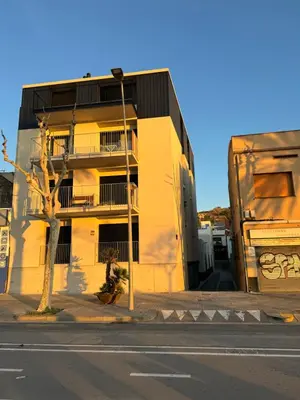 a yellow building on the side of a street at Apartamento de una habitación con terraza grande cerca de Barcelona in Badalona