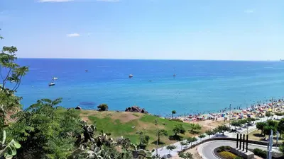 a beach with a crowd of people and the ocean at Carmen Seaview & Beach - Apartment in Montgat