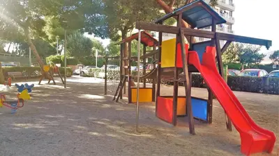 a playground with a slide in a park at Carmen Seaview & Beach - Apartment in Montgat