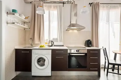a kitchen with a washing machine and a sink at Lodging Apartments Almirall Beach 52 in Barcelona