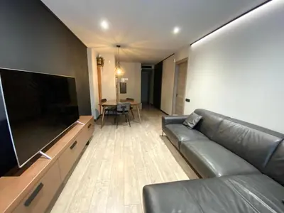 a living room with a couch and a large flat screen tv at Gaudi Comfort in Barcelona