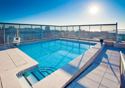 a swimming pool on the roof of a building at Ilunion Barcelona in Barcelona