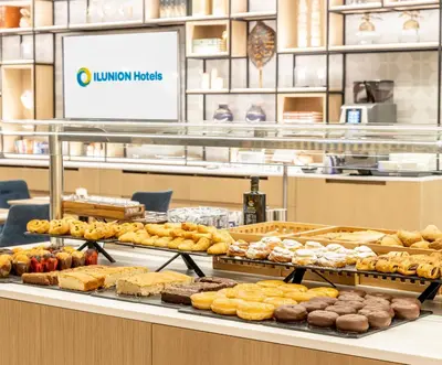 a bakery with many different types of pastries on display at Ilunion Barcelona in Barcelona