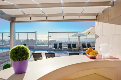 a table with a bowl of fruit on top of a building at Ilunion Barcelona in Barcelona