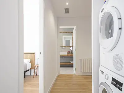 a kitchen with a washer and dryer in a room at Apartamento exclusivo a 15 min de Barcelona in Sant Cugat del Vallès