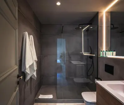 a bathroom with a shower with a toilet and a sink at Lovely 6 BR Flat in L'Eixample in Barcelona