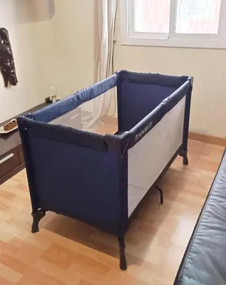 a blue bed in a room with a couch at My best house BCN in Barcelona