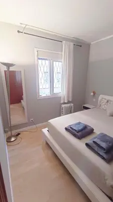 a white bedroom with a bed and a window at My best house BCN in Barcelona