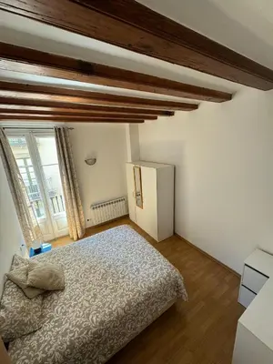 a bedroom with a bed and a large window at Habitacion Privada en APARTAMENTO COMPARTIDO in Barcelona