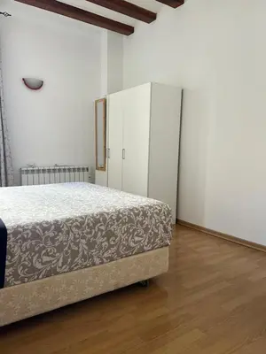 a bedroom with a bed and a white cabinet at Habitacion Privada en APARTAMENTO COMPARTIDO in Barcelona