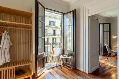 a living room with a large window and a table at Canela Homes BARCELONA BRUC in Barcelona