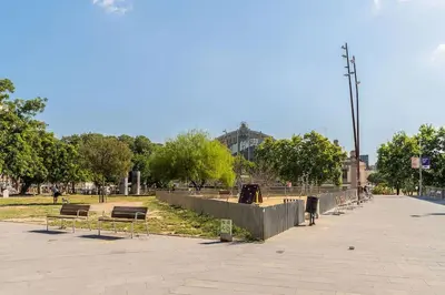 a park with benches and a fence and trees at Canela Homes BARCELONA BRUC in Barcelona