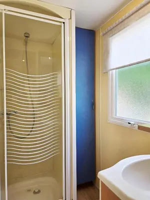 a bathroom with a shower and a sink at Camping Costa Dorada Bungalow Maia in Canet de Mar