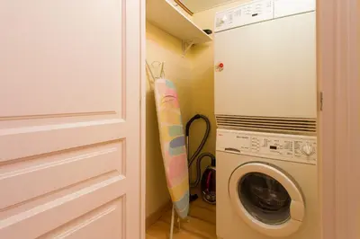 a surfboard leaning against a door next to a washing machine at Charming Central Apartment Big Sunny Terrace! in Barcelona