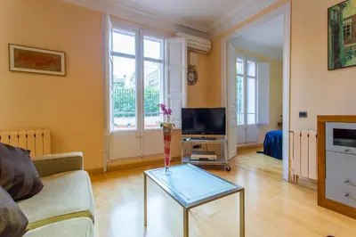 a living room with a couch and a glass table at Charming Central Apartment Big Sunny Terrace! in Barcelona