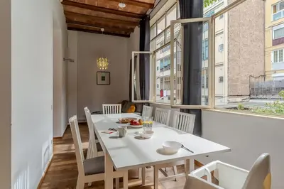 a dining room with a white table and chairs at Canela Homes BARCELONA LIGHT in Barcelona