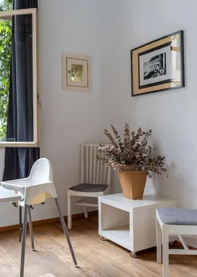 a room with white chairs and a plant on a table at Canela Homes BARCELONA LIGHT in Barcelona