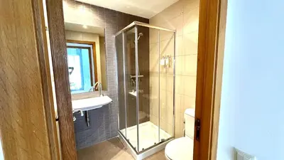 a bathroom with a shower and a toilet and a sink at Dúplex 2 hab con terraza by Prestigi in Terrassa