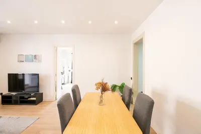 a dining room with a wooden table and chairs at Beautiful apartment with terrace in Barcelona in Barcelona