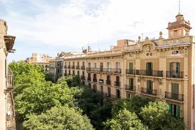 a large building with trees in front of it at Beautiful apartment with terrace in Barcelona in Barcelona