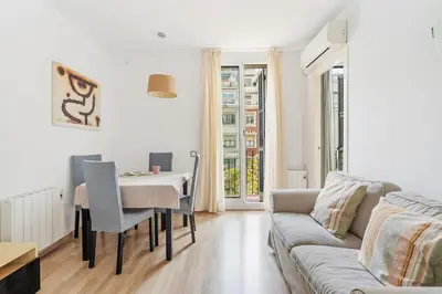 a living room with a table and a couch at Avenida Gaudí View 2-Min to Sagrada in Barcelona