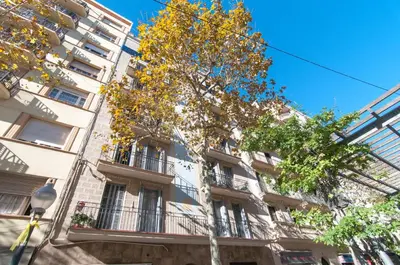 a tall building with a tree in front of it at Avenida Gaudí View 2-Min to Sagrada in Barcelona