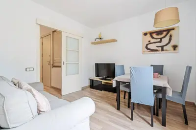 a living room with a white couch and a table at Avenida Gaudí View 2-Min to Sagrada in Barcelona