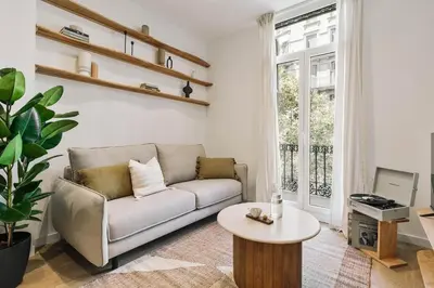 a living room with a couch and a table at Pontone - 2 bedrooms and balcony in Eixample Dreta in Barcelona