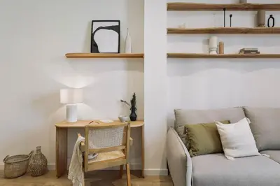 a kitchen with white cabinets and a table at Pontone - 2 bedrooms and balcony in Eixample Dreta in Barcelona